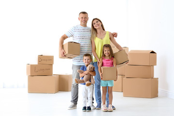 Fototapeta na wymiar Family with cardboard boxes at new home