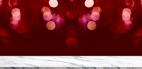 Empty marble table with sparkling red bokeh lights background,Holiday greeting card concept.Mock up...