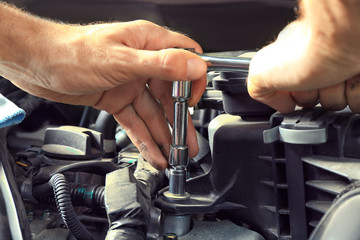 Car mechanic providing car service, closeup