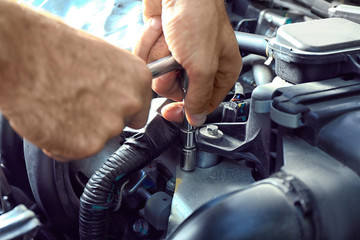 Car mechanic providing car service, closeup