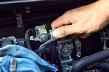 Car mechanic providing car service, closeup