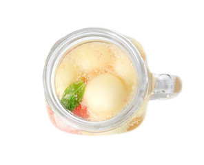 Mason jar with melon ball drink on white background