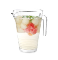 Glass pitcher with melon ball drink on white background