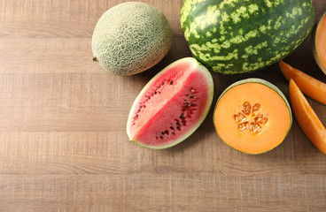 Fresh ripe melons and watermelon on wooden background