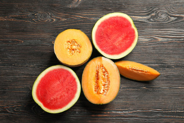 Fresh ripe melons and watermelon on wooden background