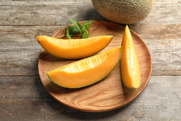 Composition with fresh ripe melon on wooden background