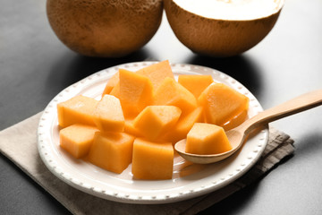 Plate with sliced melon on table, closeup