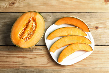 Composition with fresh ripe melon on wooden background