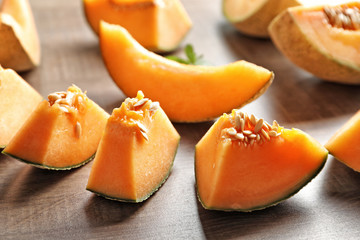 Fresh sliced melon on wooden background