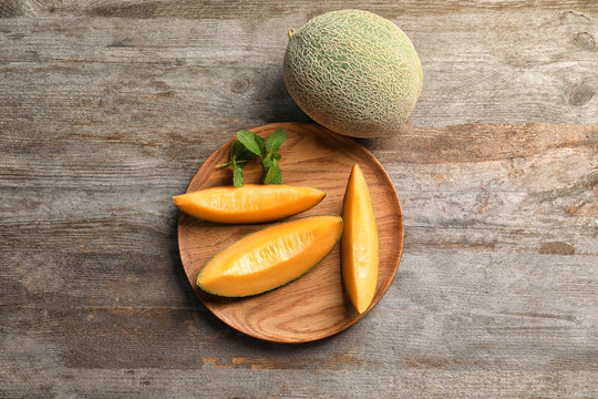 Composition with fresh ripe melon on wooden background