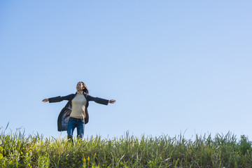 A beautiful woman standing in the grassland