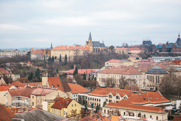 Obraz premium View from a high point. A beautiful view from above on the streets, roads and roofs of houses in Prague. Traditional ancient urban architecture.