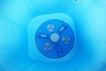 the inside of blue wasing machine plastic tank