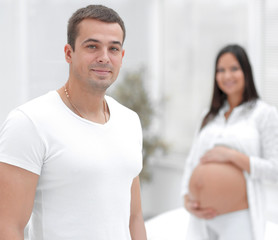 closeup of husband and pregnant wife ,standing in the new living room