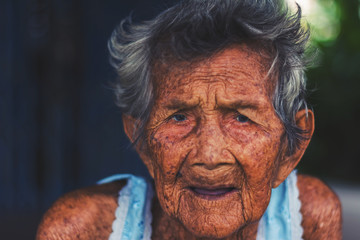 depress and helpless elderly woman, grandma sitting outdoor waiting for children come back home