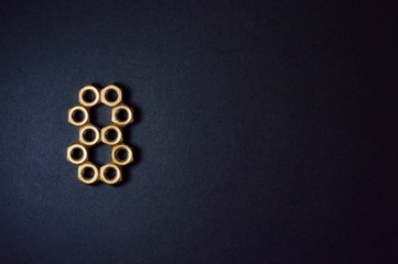 Fototapeta na wymiar golden mechanic nuts forming number eight