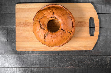 Chocolate cupcake on a wooden cutting board top view