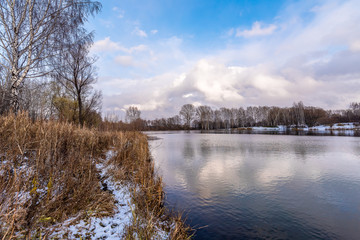 Naked autumn trees on the shore of the lake