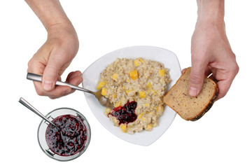 An elderly, poor but intelligent man eats morning porridge with pumpkin and jam concept