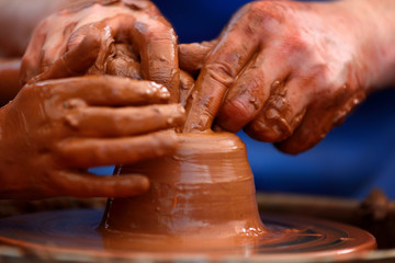 Potter making ceramic pot on the pottery wheel