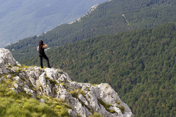 Fototapeta na wymiar woman hiker on green mountain