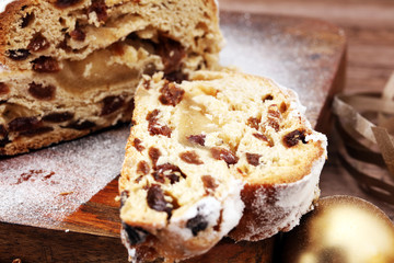 Christmas stollen on wooden cutting board. Traditional German festive baking