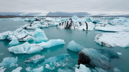 Aerial over icebergs floating in Jokulsarlon Lagoon by the southern coast of Iceland