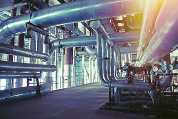 Equipment, cables and piping as found inside of a modern industrial power plant