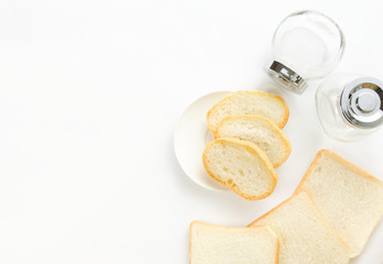 The bread on a white background and have the glass bottle located near.