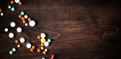 Drugs and pills on a wooden table. Various means to prevent cold