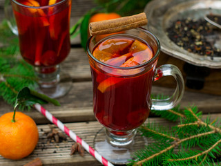 Hot spiced drink from infused tea with rum and mandarin