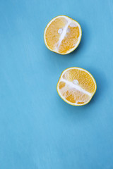 Fresh orange cut with space on blue wooden background