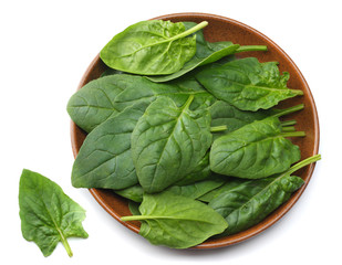 spinach leaves in bowl isolate on white background top view