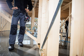 Carpenter Standing With Hands On Hips At Site