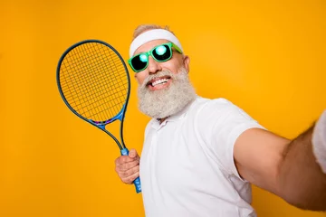 Foto op Canvas Competetive emotional cool grandpa with humor grimace exercising holding equipment, shoting photo. Body care, healthcare, weight loss, game, coach, champion, funky lifestyle © deagreez