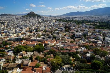 Fototapeta na wymiar View of beautiful Athens cityscape from Acropolis seeing building architecture, Mount Lycabettus, mountain, blue sky and floating white cloud background