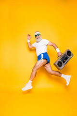 Fototapeta na wymiar Dreamy cheerful excited sporty aged funny sexy grandpa in eyewear with recorder in hand. Old school, swag, fooling qround, gym, technology, success, hip hop, chill, party, leisure