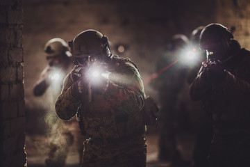 rangers during the military operation with laser sights and lanterns. - obrazy, fototapety, plakaty