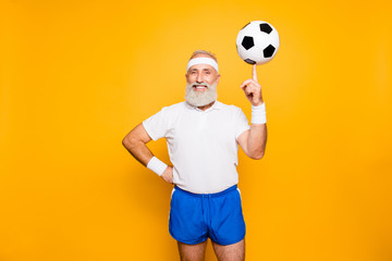 Bodycare, healthcare, weight loss, pride, strength, leadership, motivation, happiness, authority, gym concept. Cool funny modern competetive pensioner, leader, champion plays with ball
