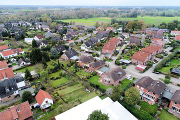 Suburban settlement in Germany with terraced houses, home for many families, aerial view with drone