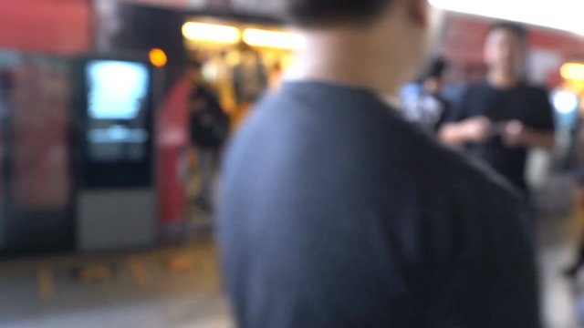 The blurred with many people getting out of skytrain at station