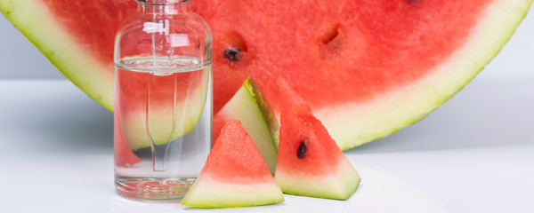 flavor of ripe watermelon in a transparent bottle, on a white background