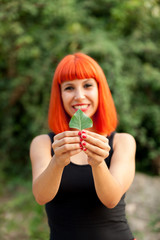 Red hair girl with a tree leaf