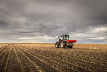 Tractor spreading artificial fertilizers