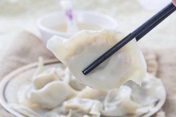 Close-Up Of Chinese Dumplings With Chopsticks.