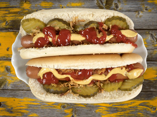 two hotdogs on an old wooden table