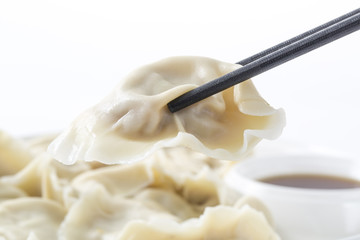 Close-Up Of Chinese Dumplings With Chopsticks.