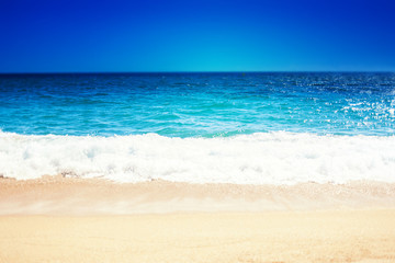 Fototapeta na wymiar Sea Beach and Soft wave of blue ocean. Summer day and sandy beach background.