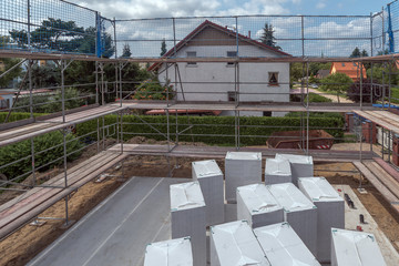 Scaffolding on a house. Construction of new houses with scaffolding