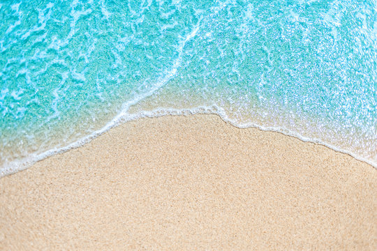 Sea Beach and Soft wave of blue ocean.  Summer day and sandy beach background.